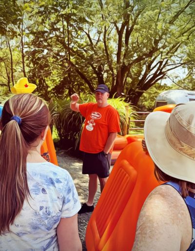 Safety briefing before river tubing on French Broad River.