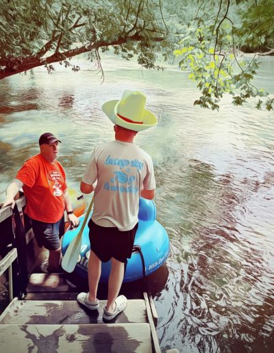 Putting river tube in water on French Broad River in Asheville, NC.