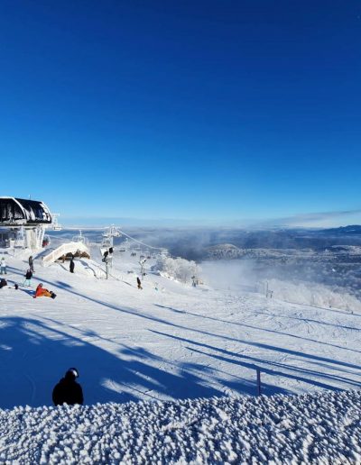 Snow skiing and snowboarding on slopes at ski resort in Beech Mountain, NC.
