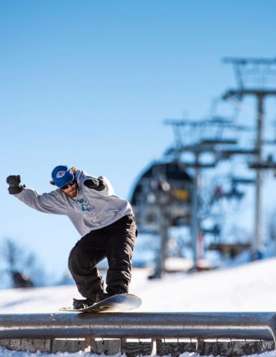 Person doing snowboarding terrain park at Beech Mountain Ski Resort.