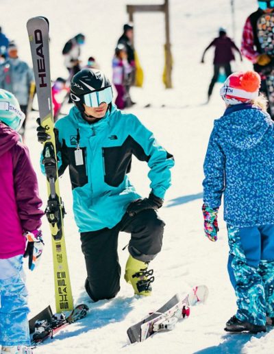 Man giving ski instruction to children at Beech Mountain ski resort in Boone, NC.