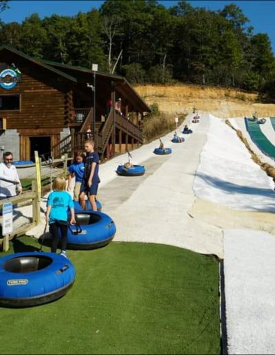 Snowless tubing riders going up hill in Hendersonville, NC.