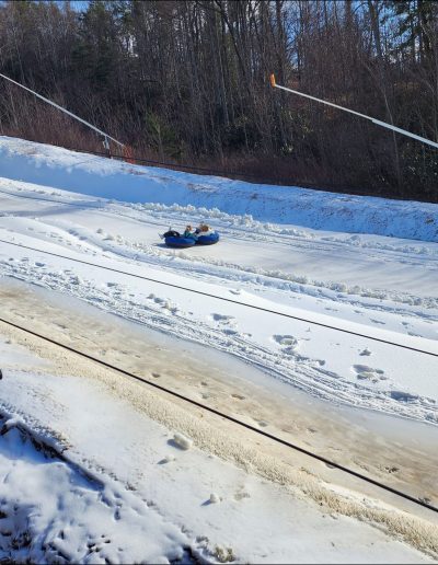Kid snowtubing on hill near Asheville, NC.