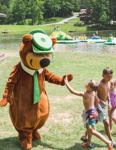 Yogi Bear with kids at lake with inflatables at campground near Black Mountain, NC.