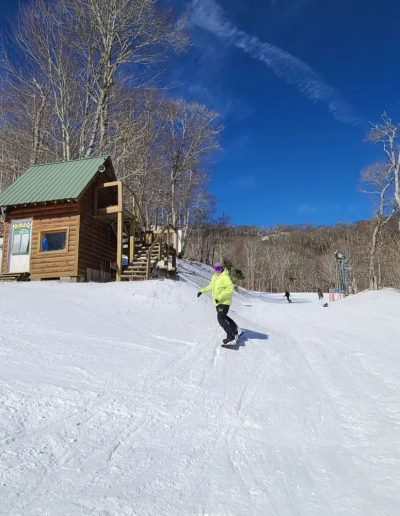 Woman snowboarding at Sugar Mountain resort near Boone, NC.