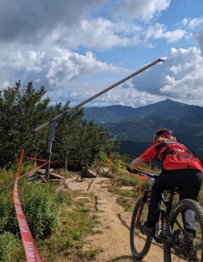 Person mountain biking at Sugar Mountain ski resort near Boone, NC.