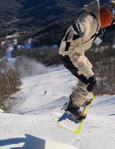 Person snowboarding at ski mountain in NC mountains.