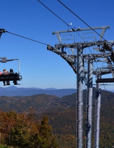 People riding scenic chairlift at Sugar Mountain resort near Boone, NC.