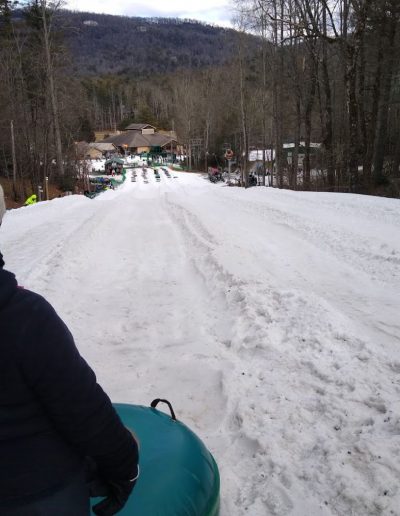 Person on snow tube at ski snowboard resort near Greenville, SC.