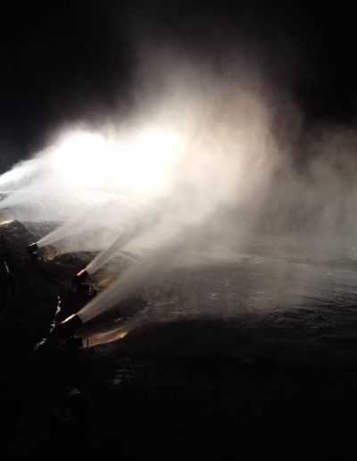 night snow tubing with lighted slopes