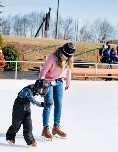 Mom and son ice skating at ski resort near Hickory, NC.