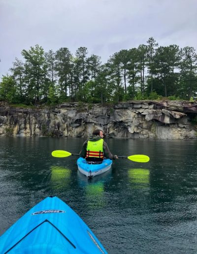 Guests paddling kayaks on Fantasy Lake quarry lake