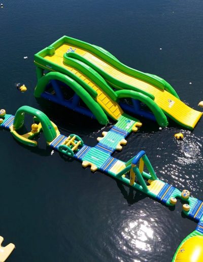 Guests wearing life jackets on Fantasy Lake inflatable water attractions