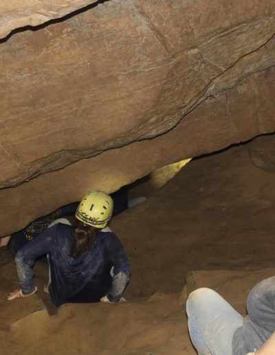 Visitors crawling through natural limestone passages at Worley’s Cave