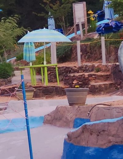 Swimmers enjoying the country swimming-hole atmosphere at Sun Crest Water Park