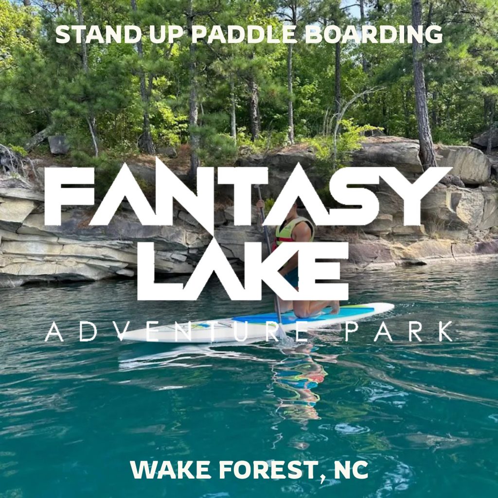 Families enjoying the floating inflatable water park at Fantasy Lake in Wake Forest NC