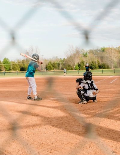 Youth softball batter and catcher at Burlington City Park.