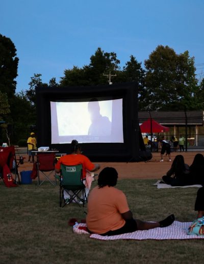 Families watching an outdoor movie at Burlington City Park.