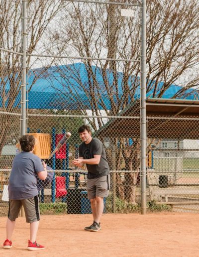Two players practicing on a softball field at Burlington City Park.