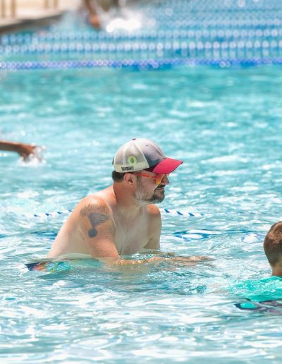 Adult and children swimming together at Burlington Aquatics.