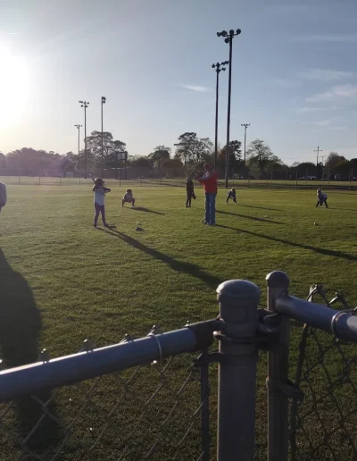 Players practicing on a sunlit sports field at Burlington City Park.