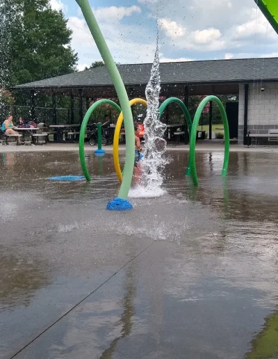 Colorful arches and bubbling water jets at Burlington Splash Park.