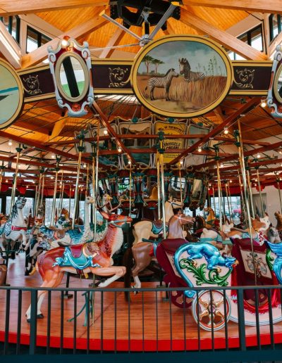 Families riding the historic carousel at Burlington City Park.
