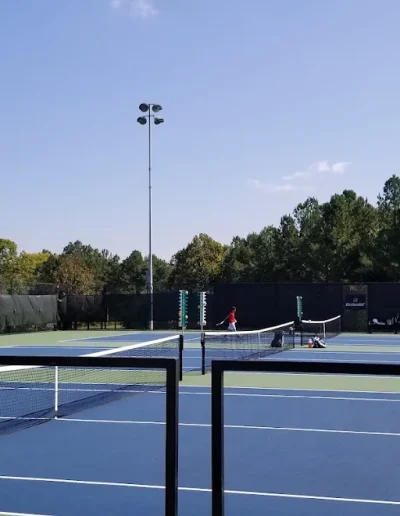 Tennis players using the outdoor courts at Burlington City Park.