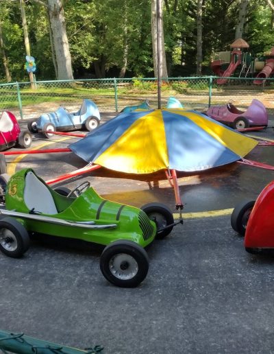 Colorful children’s cars around a circular ride at Santa’s Land in Cherokee, NC