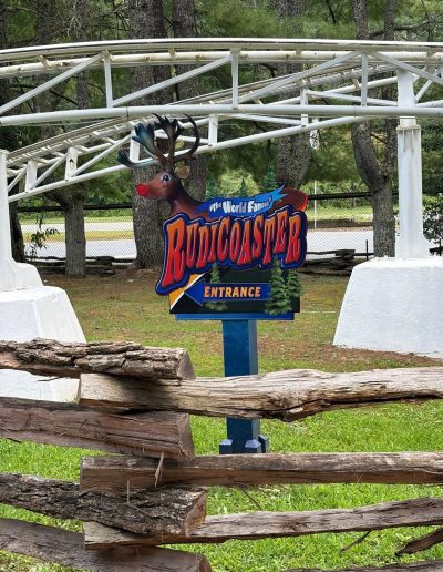 Rudicoaster entrance sign and white roller coaster track at Santa’s Land in Cherokee, NC