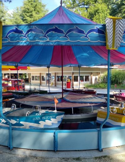 Small boat ride beneath a blue canopy at Santa’s Land in Cherokee, NC