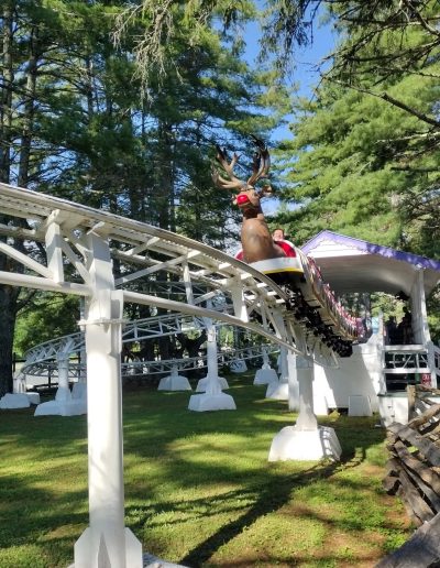 Reindeer-themed Rudicoaster train rounding a track at Santa’s Land in Cherokee, NC