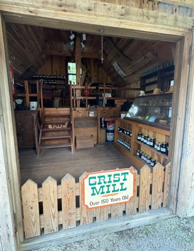 Grist mill display inside a wooden building at Santa’s Land in Cherokee, NC