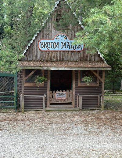 Broom Maker workshop sign on a wooden building at Santa’s Land in Cherokee, NC