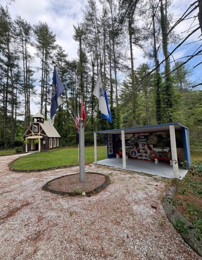 Flags and outdoor display along a path at Santa’s Land in Cherokee, NC