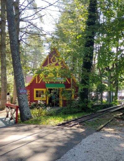 Train tracks beside a colorful woodland building at Santa’s Land in Cherokee, NC