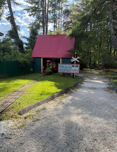 Train Depot and tracks along a wooded path at Santa’s Land in Cherokee, NC