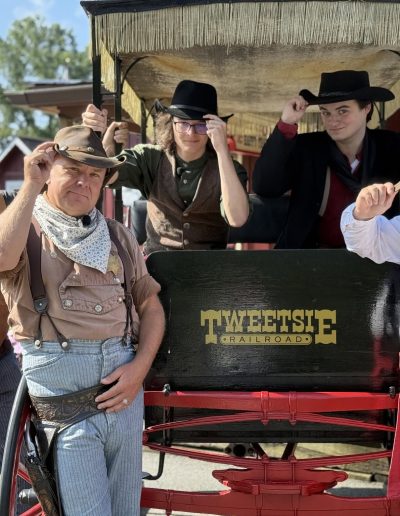 Tweetsie Railroad Wild West cast beside a stagecoach