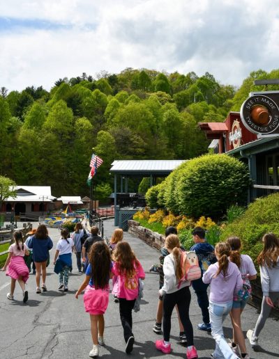 Visitors walking through Tweetsie Railroad theme park