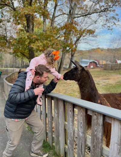 Family feeding a deer at Tweetsie Railroad