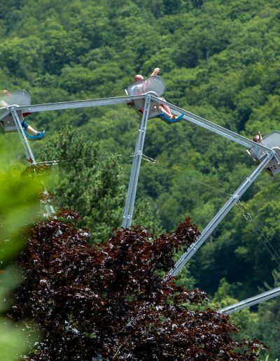 Riders on an elevated thrill ride at Tweetsie Railroad