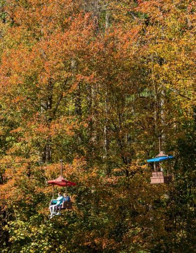 Tweetsie Railroad chairlift traveling through fall trees