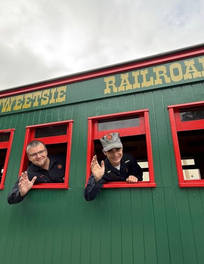 Passengers looking from a Tweetsie Railroad train car