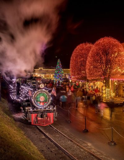 Steam train arriving during Tweetsie Christmas