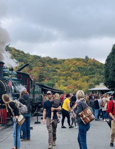 Steam locomotive at the Tweetsie Railroad station in fall