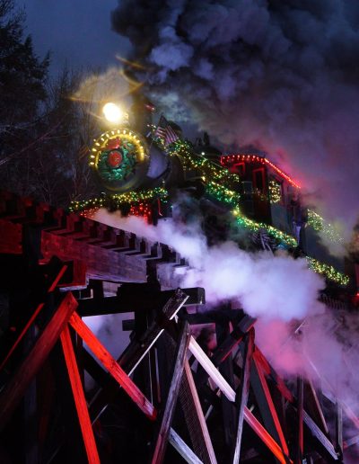 Tweetsie Christmas train crossing a trestle at night