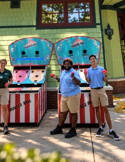 Visitors at a carnival game booth at Pullen Park