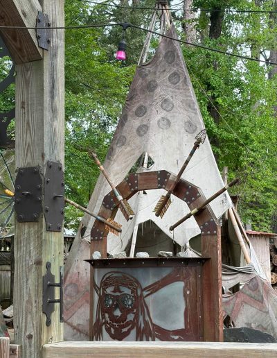 Painted tipi beside trees at Deadwood near Williamston, NC