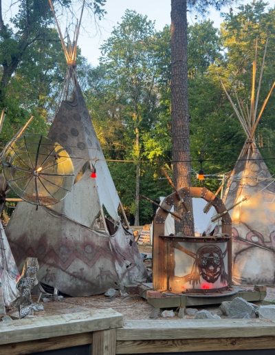 Painted tipis lit among trees at Deadwood near Williamston, NC