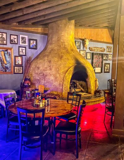 Stone fireplace and dining tables inside Deadwood near Williamston, NC